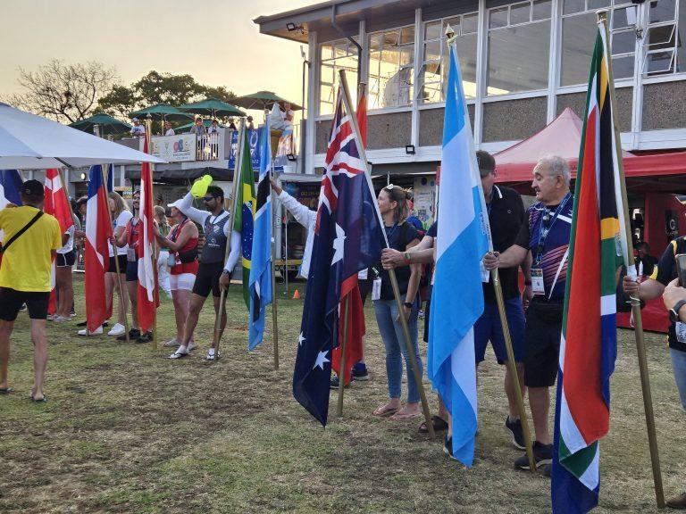 people holding flags, rowing regatta