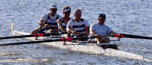 five men in a rowing boat.